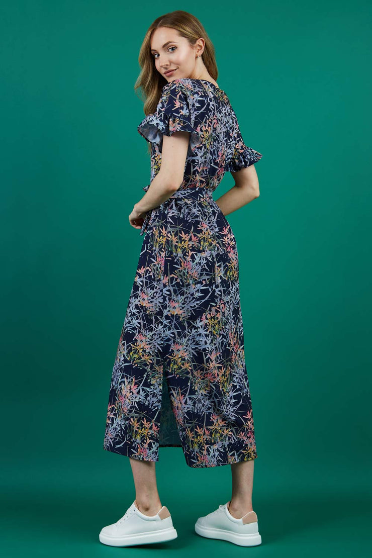 brunette model is wearing diva catwalk carella short sleeve printed midi dress with a belt in navy floral print back