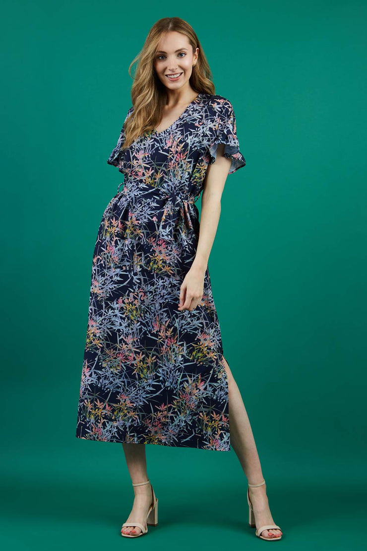 brunette model is wearing diva catwalk carella short sleeve printed midi dress with a belt in navy floral print front
