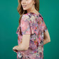 brunette model is wearing divacatwalk floral short sleeved printed top back