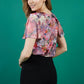 brunette model is wearing divacatwalk floral short sleeved printed top with black pencil trousers