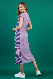 model is wearing diva catwalk midi length printed dress with short sleeves and belt detail in purple back