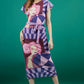 model is wearing diva catwalk midi length printed dress with short sleeves and belt detail in purple front