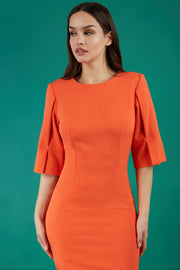 model is wearing divacatwalk chiswick pencil dress rounded neck with short sleeve in fiesta orange front