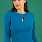 Brunette model is wearing diva catwalk casares swing dress with a keyhole neckline three quarter sleeve dress with pocket detail in teal front