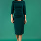 A brunette model is wearing a round neckline pencil dress with pleating on the tummy area in forest green front image