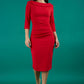A brunette model is wearing a round neckline pencil dress with pleating on the tummy area in red front image