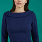 A brunette model is wearing a round neckline pencil dress with pleating on the tummy area in navy front image