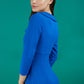 Brunette model is wearing a cobalt blue pencil three quarter sleeve dress with assymetric neckline and pleating around tummy area back image