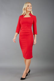 model is wearing diva catwalk plaza sheath dress with high neck Trapezium neckline cutout and three quarter sleeve pretty dress in red front