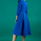 Model is wearing a split neckline sleeved blue swing Aline dress from Diva Catwalk back image