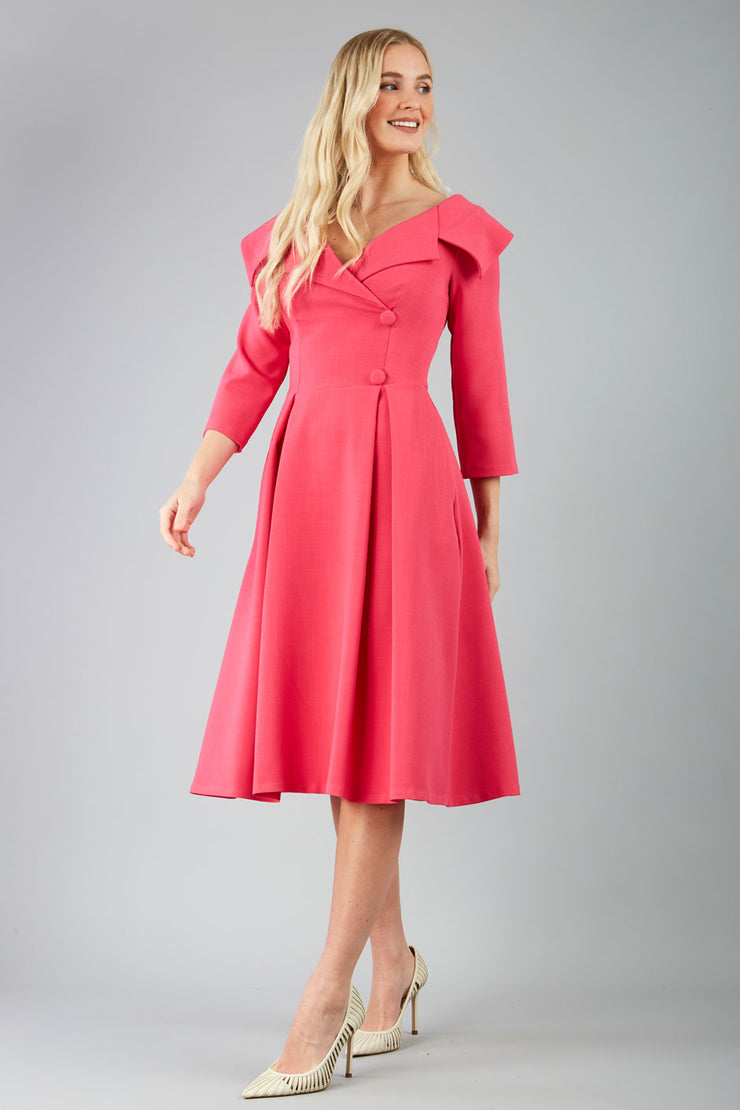 model is wearing diva catwalk gatsby swing dress with pocket detail and wide v-neck collar and buttons down the front panel in hibiscus pink front
