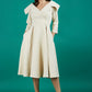 Brunette model is wearing a sleeved beige oversized collar swing dress with button detail at the front and pockets in the skirtmodel is wearing diva catwalk gatsby swing dress with pocket detail and wide v-neck collar and buttons down the front panel in sandshell beige front
