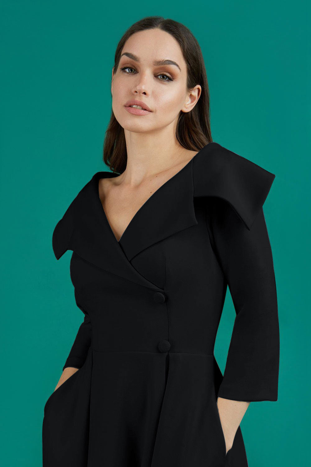 model is wearing diva catwalk gatsby swing dress with pocket detail and wide v-neck collar and buttons down the front panel in black front