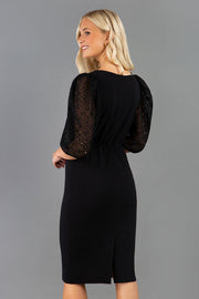 Blonde model is wearing Diva Catwalk Zermatt Lace Short Sleeved Black Pencil skirt Dress with a Belt Detail at the front good for corporate  events and as an office dress or workwear style back