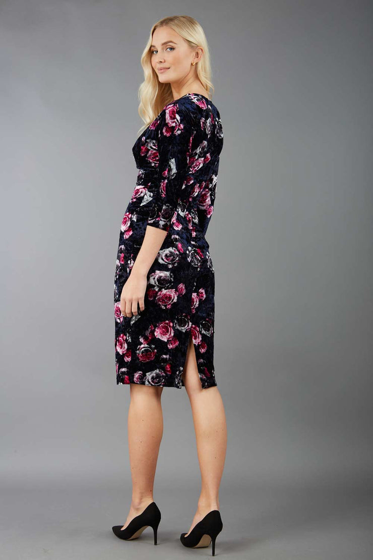 A blonde model is wearing a velvet pencil sweetheart neckline dress by diva catwalk in floral velvet print back image