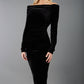 A blonde Model is wearing an off shoulder bardot neckline velvet stretch midi dress in black by diva catwalk