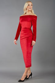 A blonde Model is wearing an off shoulder bardot neckline velvet stretch midi dress in red by diva catwalk