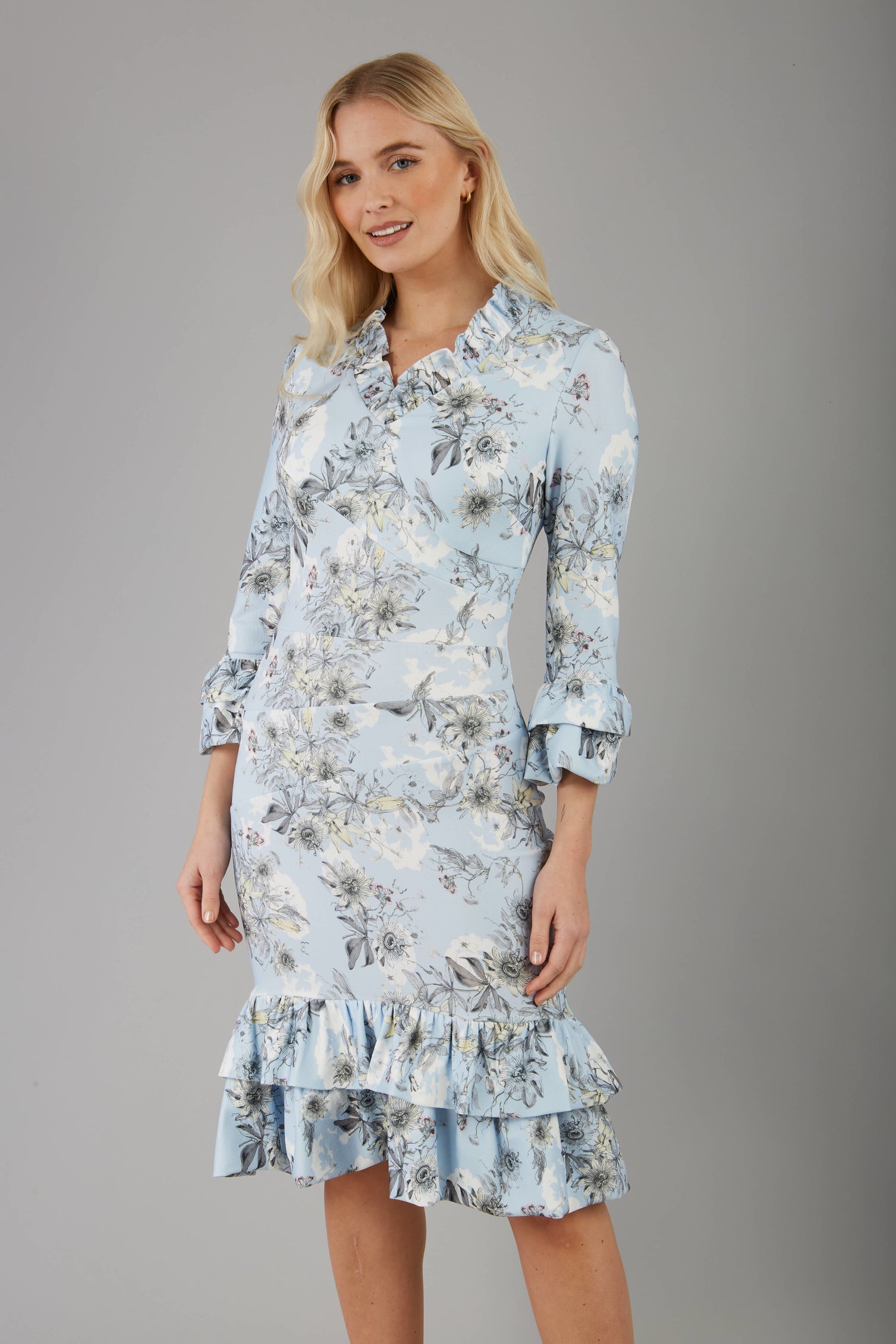 model is wearing diva catwalk fern printed dress with rushes and sleeves in light blue front