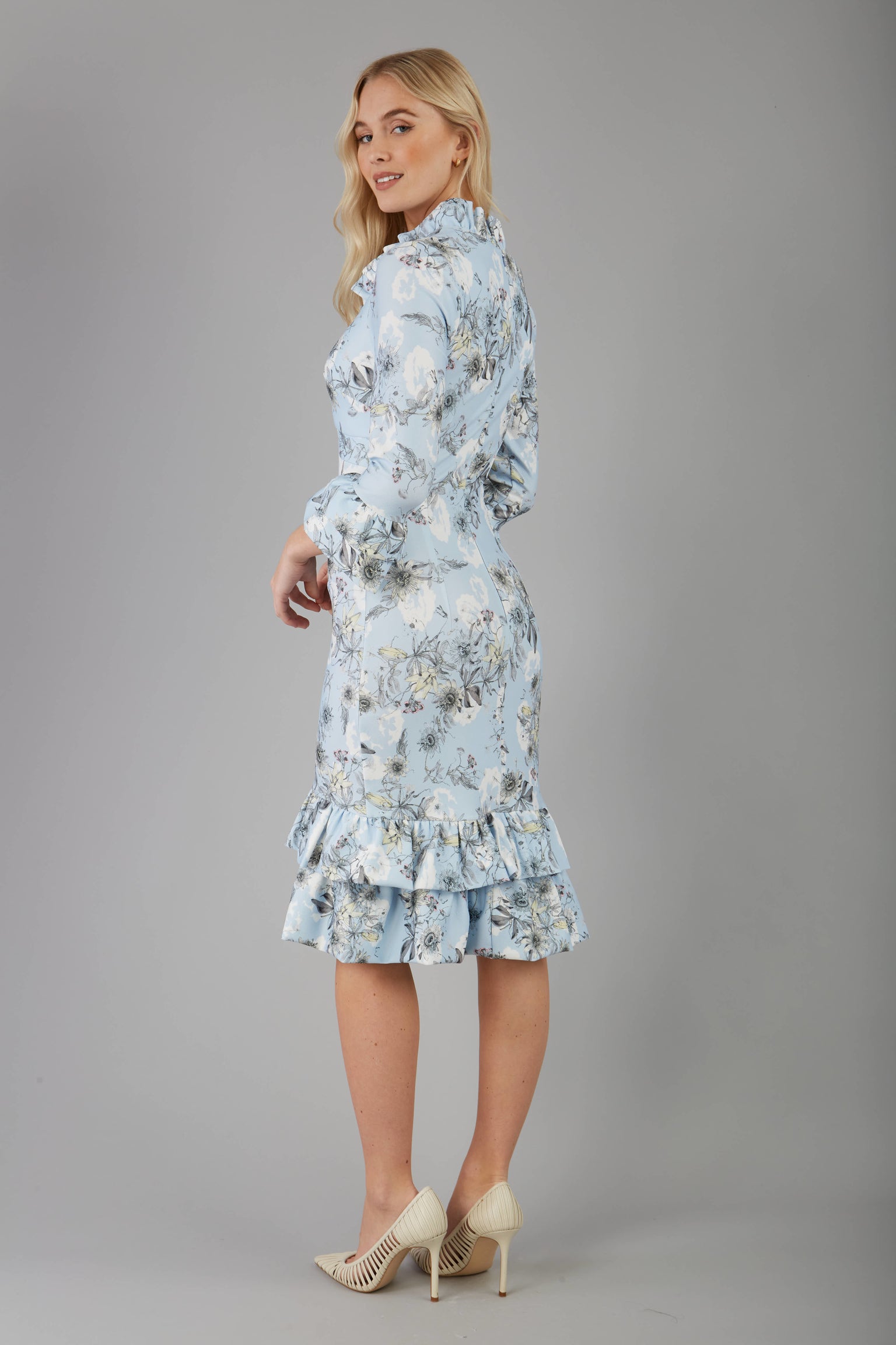 model is wearing diva catwalk fern printed dress with rushes and sleeves in light blue back