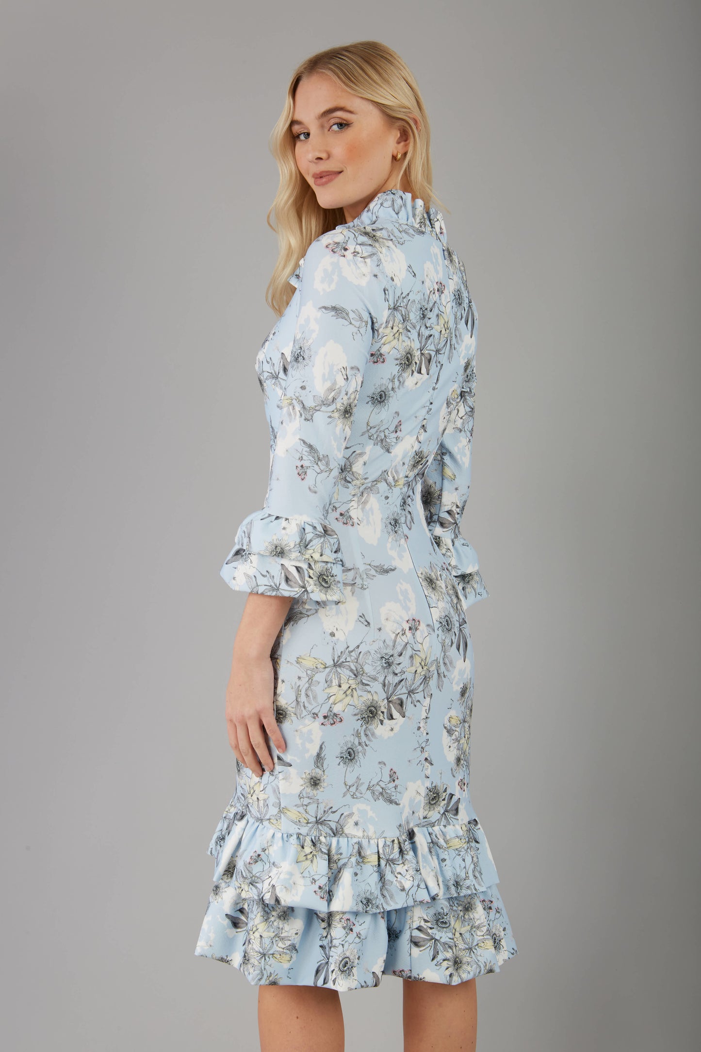 model is wearing diva catwalk fern printed dress with rushes and sleeves in light blue back