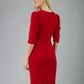 blonde model is wearing diva catwalk lucretis rounded neckline sleeved pencil dress with  rushing on shoulders and rushed detail on a side of a waistline in red back