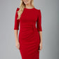 blonde model is wearing diva catwalk lucretis rounded neckline sleeved pencil dress with  rushing on shoulders and rushed detail on a side of a waistline in red front