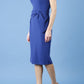 model is wearing diva catwalk Ester cap sleeve pencil dress with v-neck and bow detail at the front in midnight blue side