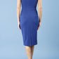 model is wearing diva catwalk Ester cap sleeve pencil dress with v-neck and bow detail at the front in midnight blue back
