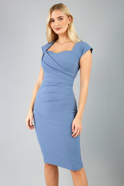 blonde model is wearing diva catwalk stella sweetheart neckline cap sleeve pencil dress in stone blue front