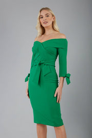 blonde model is wearing diva catwalk mulberry pencil off-shoulder dress with a bow detail on 3/4 sleeves and criss cross on a front panel in emerald green front