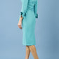 blonde model is wearing diva catwalk mulberry pencil off-shoulder dress with a bow detail on 3/4 sleeves and criss cross on a front panel in aqua green side