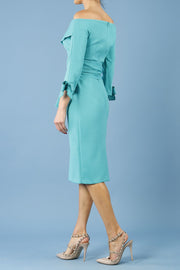 blonde model is wearing diva catwalk mulberry pencil off-shoulder dress with a bow detail on 3/4 sleeves and criss cross on a front panel in aqua green side