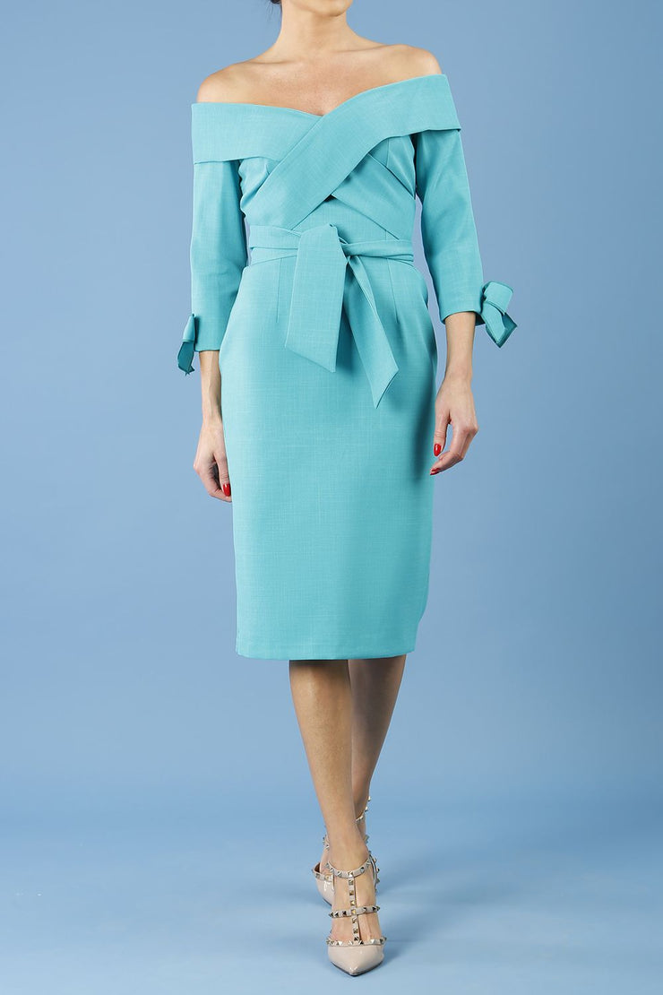 blonde model is wearing diva catwalk mulberry pencil off-shoulder dress with a bow detail on 3/4 sleeves and criss cross on a front panel in aqua green front