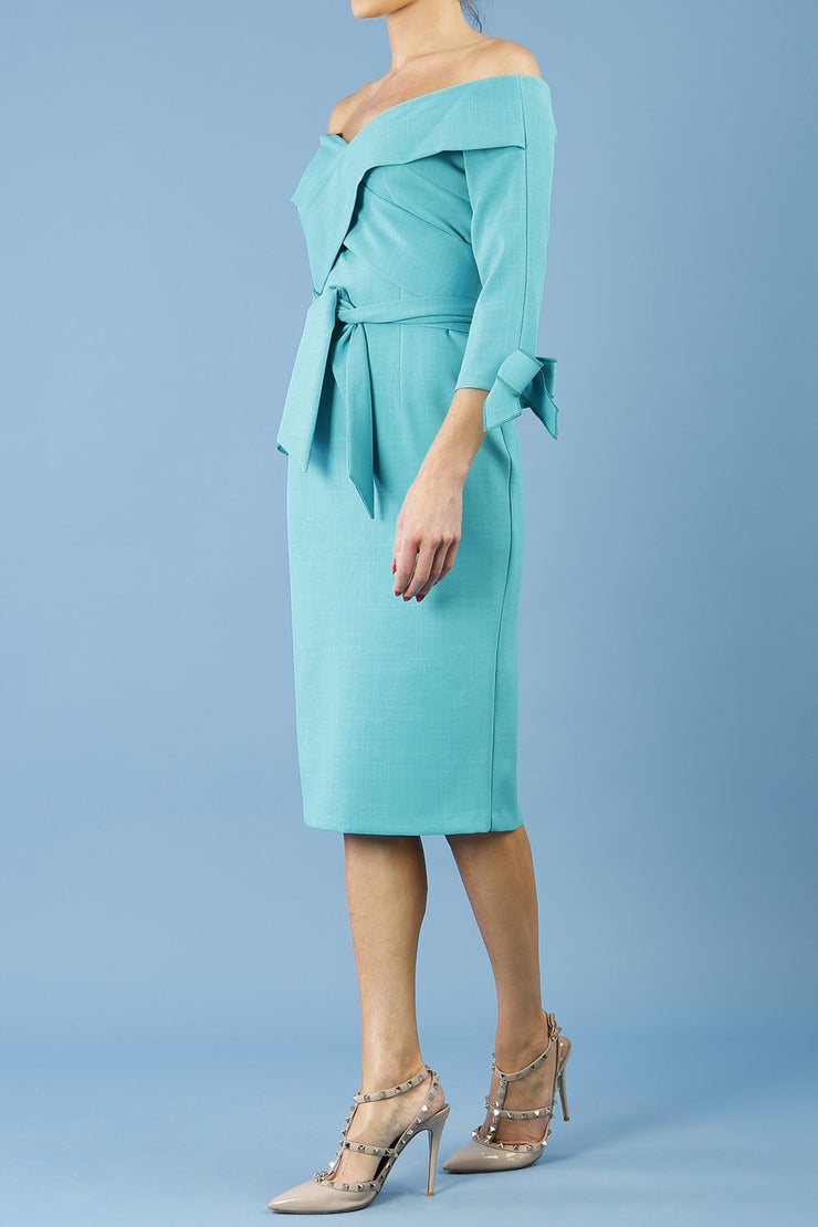 blonde model is wearing diva catwalk mulberry pencil off-shoulder dress with a bow detail on 3/4 sleeves and criss cross on a front panel in aqua green front