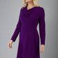 blonde model is wearing diva catwalk moraig swing long sleeve dress with high cowl neckline and wrap skirt in deep purple front