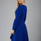 blonde model is wearing diva catwalk moraig swing long sleeve dress with high cowl neckline and wrap skirt in cobalt blue front