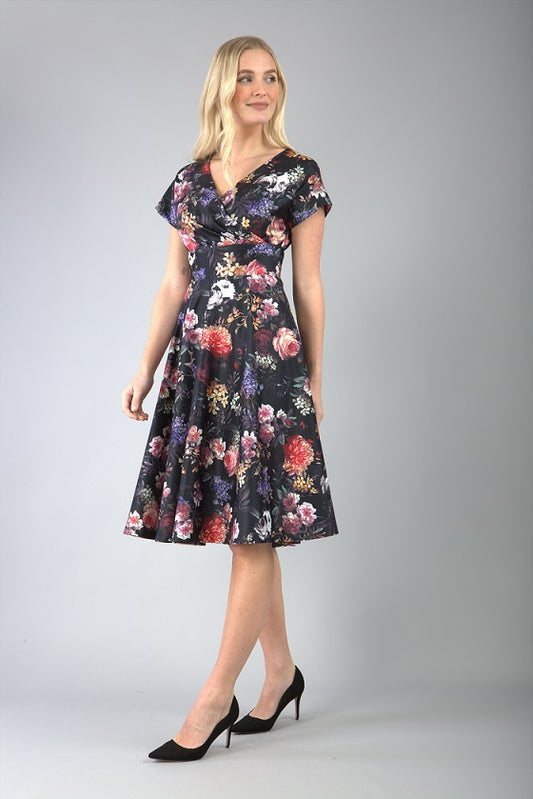 blonde model is wearing diva catwalk boston short sleeve v-neckline a-line swing dress in dark floral print front