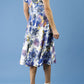 blonde model is wearing diva catwalk boston short sleeve v-neckline a-line swing dress in abstract hibiscus print back