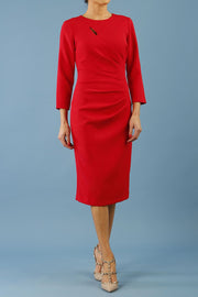 model is wearing diva catwalk miracle pencil dress with keyhole detail on a side of the front panel and gathering detail on a side or bodice panel with sleeves in scarlet red colour front
