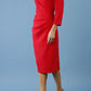 model is wearing diva catwalk miracle pencil dress with keyhole detail on a side of the front panel and gathering detail on a side or bodice panel with sleeves in scarlet red colour side
