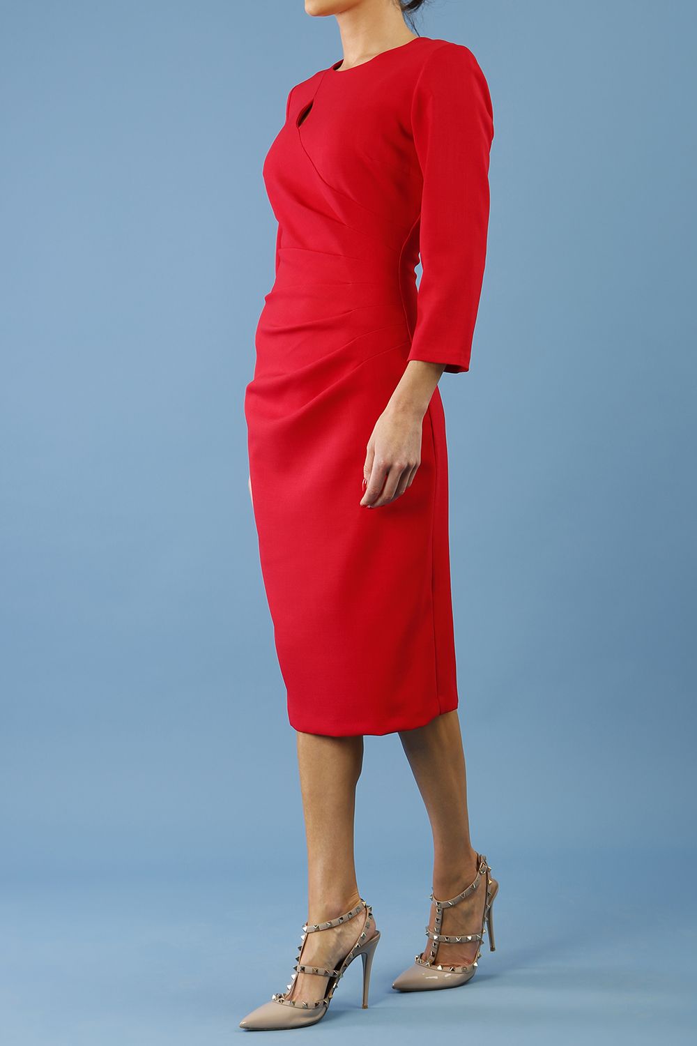 model is wearing diva catwalk miracle pencil dress with keyhole detail on a side of the front panel and gathering detail on a side or bodice panel with sleeves in scarlet red colour side