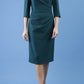 model is wearing diva catwalk lauren odd shoulder asymmetric neckline pencil dress with sleeves in forest green front