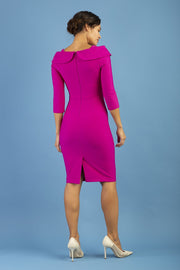 brunette model is wearing diva catwalk pencil dress with collar and a button detail on a side with 3/4 sleeve in magenta haze back