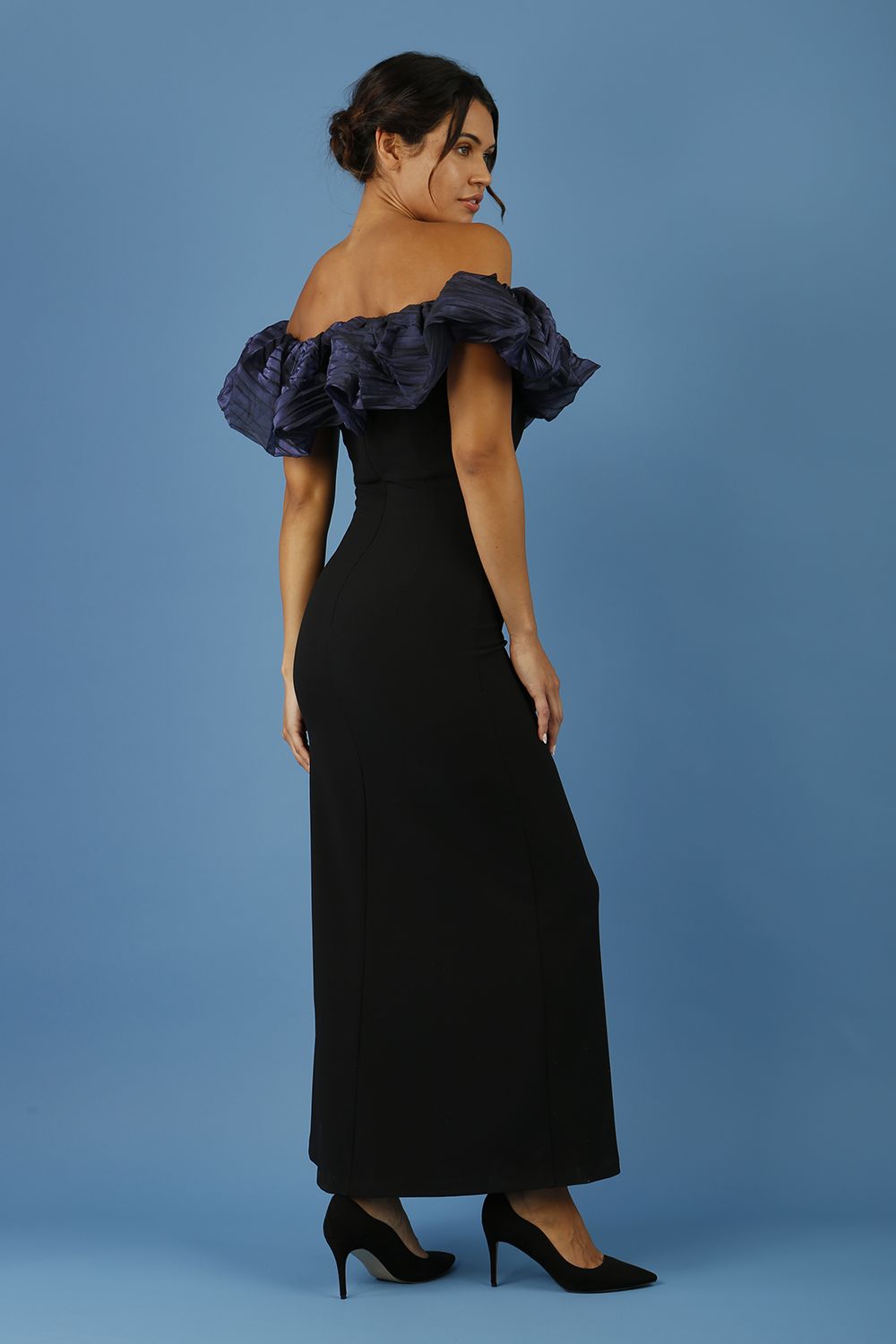 brunette model is wearing diva catwalk classique maxi black dress with off shoulder organza detail without sleeves in black and navy back