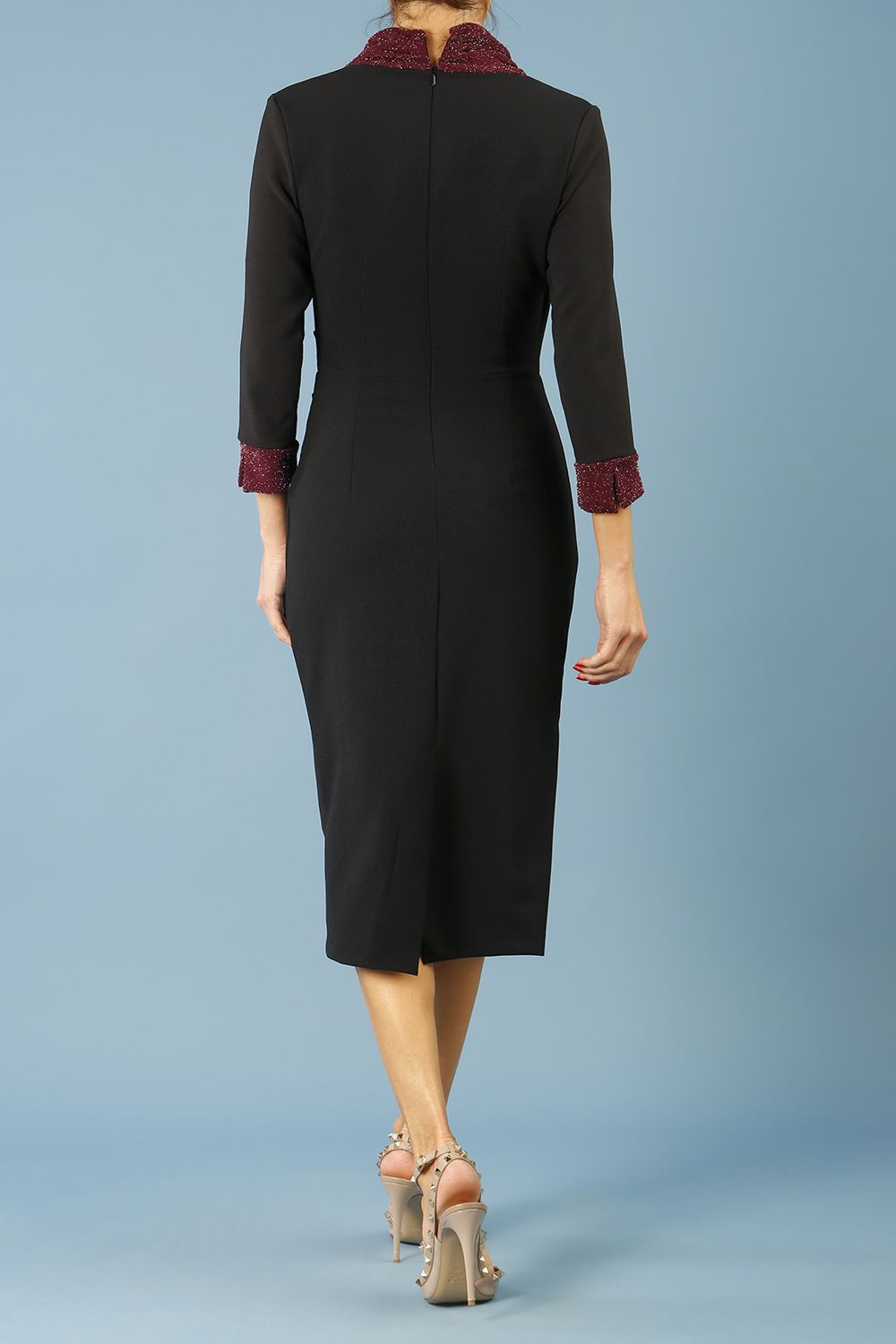 model is wearing diva catwalk osaka black pencil dress with sparkle contrasting detail on sleeves and v-neckline in black and burgundy back