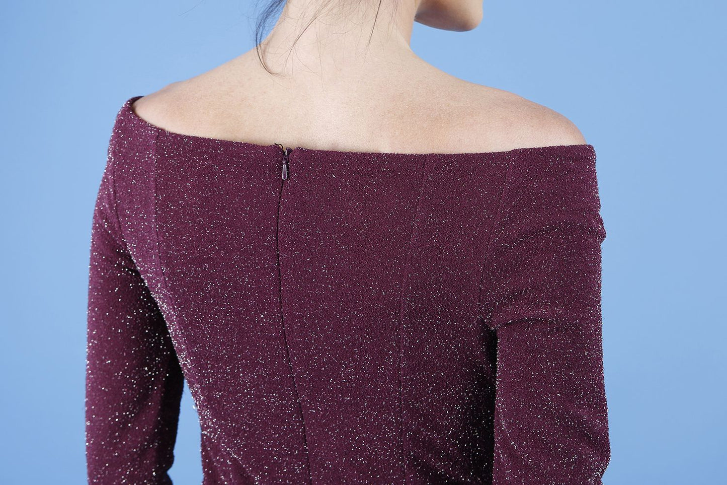 model is wearing diva catwalk neptune pencil off-shoulder dress with 3/4 sleeve in burgundy sparkle back close up