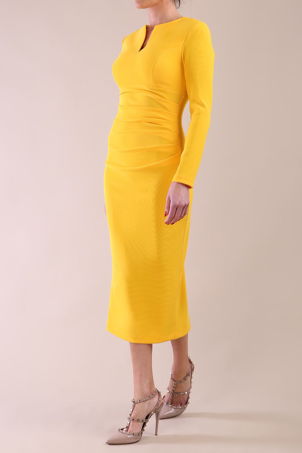 Model wearing diva catwalk Long Sleeved Lydia Midi pencil dress in Sunshine Yellow