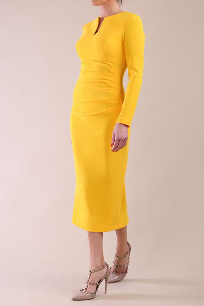 Model wearing diva catwalk Long Sleeved Lydia Midi pencil dress in Sunshine Yellow
