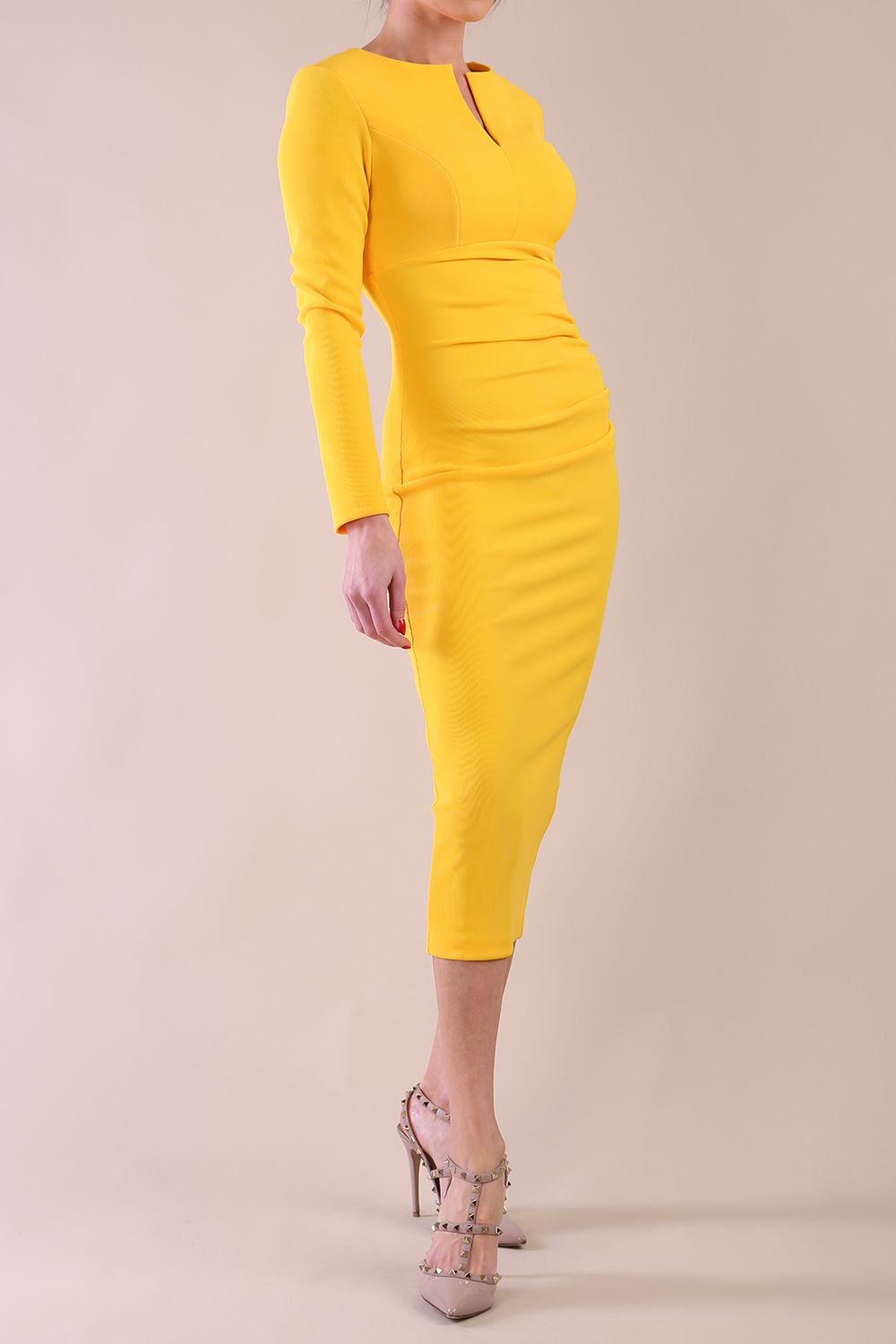 Model wearing diva catwalk Long Sleeved Lydia Midi pencil dress in Sunshine Yellow