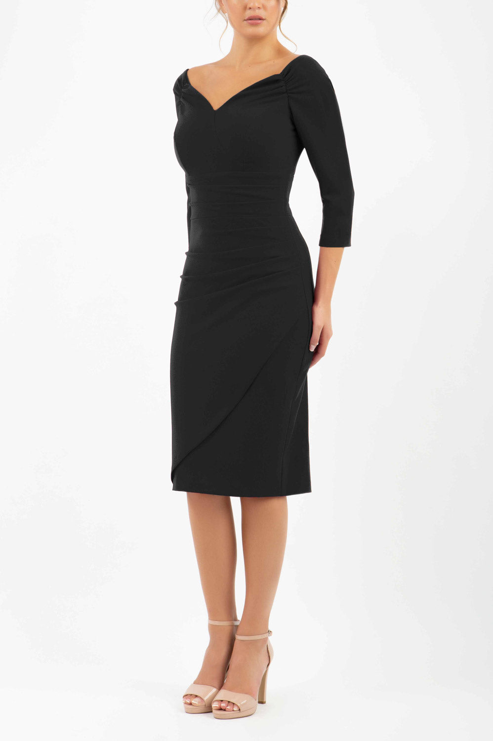brunette model wearing diva catwalk evening pencil dress off shoulder with sleeves and pleated pencil skirt in colour black front